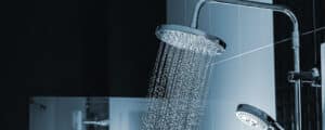 Water Flowing From Two Showerheads In A Modern Bathroom Setting.